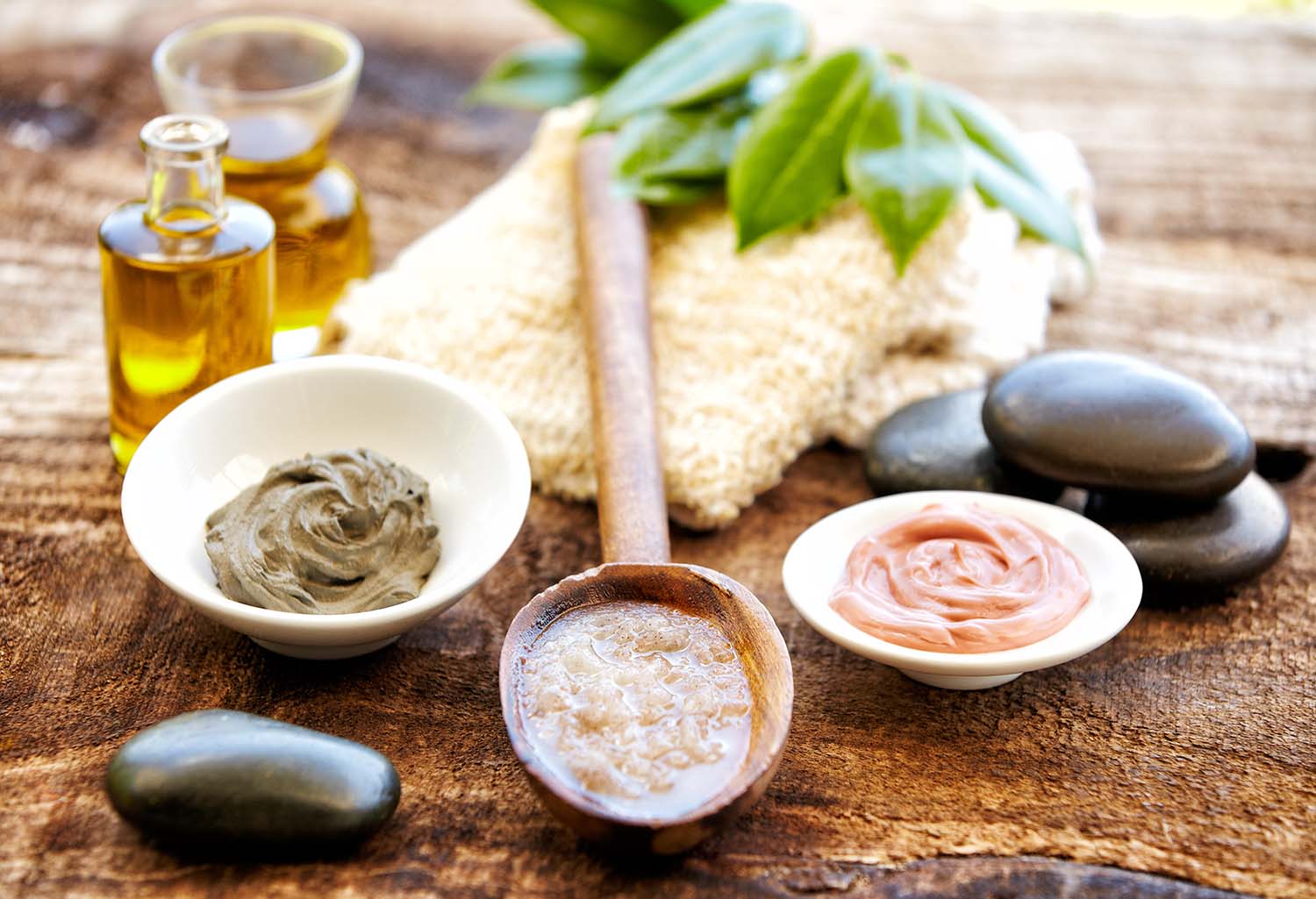 Spa still life with mud mask, salt scrubbing, massage oil