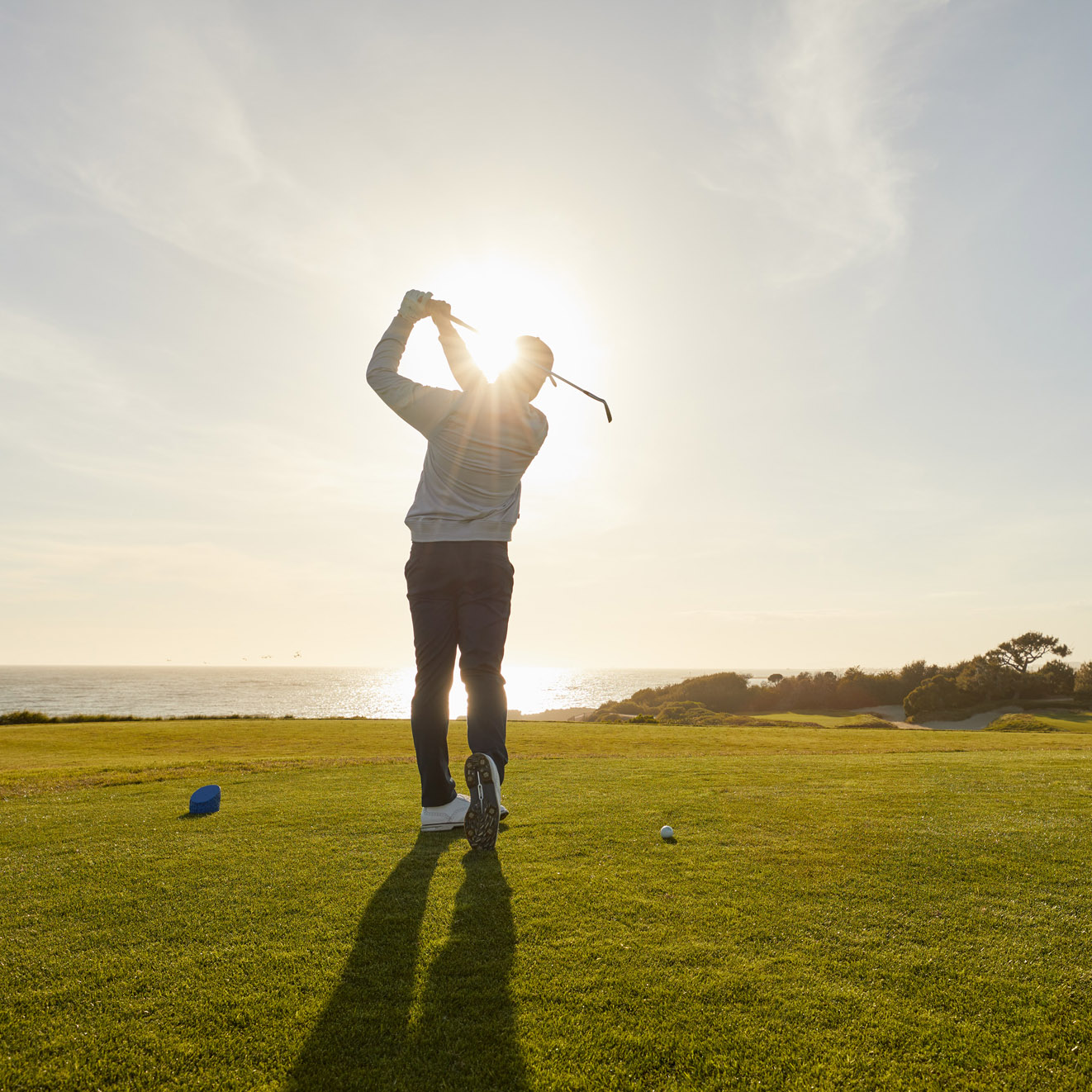 man striking golf club
